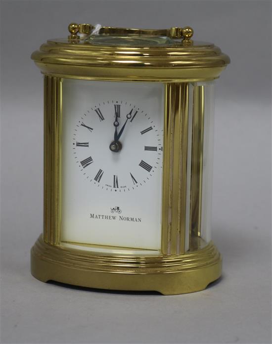 An oval gilt brass-cased carriage clock, H 12.5cm